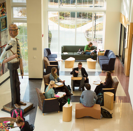 a group of students studying in the Hixson Lied Student Success main space