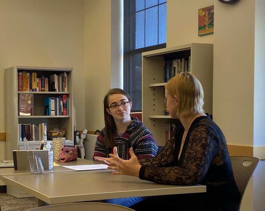 two students having a writing consultation in Hixson Lied
