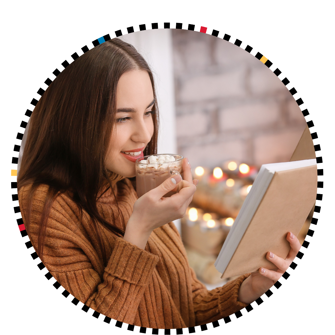 a white woman with a cup of cocoa reading a book